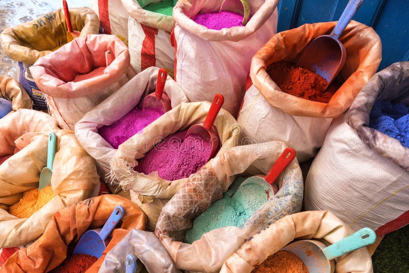 Bright moroccan dry paint in open sacks. Dyes powdered pigments, paint of different typical colors for sale. Blue town Chefchaouen, Morocco royalty free stock photos